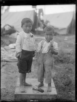 Two young Maori boys with pipes in their mouths, Northland