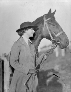Muriel Murphy holding the reins of a horse