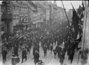 An army band leads New Zealand troops through a city on the march to the Rhine after the Armistice