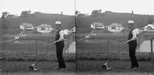 Man pushing a lawn mower