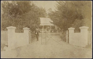 Christmas postcard showing a man standing at the gate of 'The Pines' homestead in Waipawa