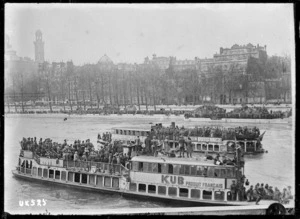 Crowded Seine ferries passing a palace on the far riverbank