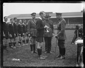 King George V presents a cup to the captain of the winning New Zealand Services Rugby Team, London