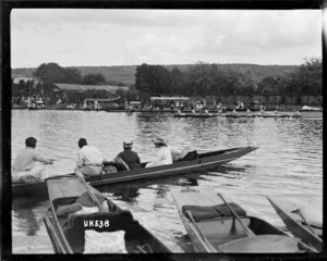 Spectators in punts watch a rowing eight at the Royal Henley Peace Regatta, England