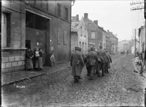 German World War I prisoners passing local inhabitants, Solesmes, France
