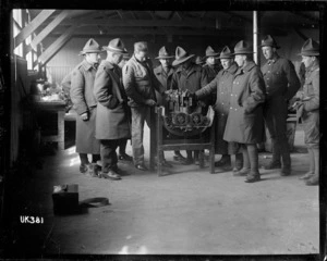 Soldiers examining a combustion engine at a camp in England