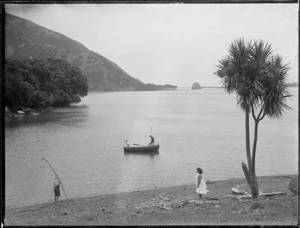 Scene with children and row-boat, at the edge of Houhora Harbour, Northland Region