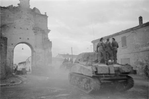 Kaye, George, 1914- : NZ Sherman tanks moving out of the town of Forli, Italy, to engage the enemy