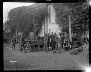 Soldiers loading barrels onto a cart, England