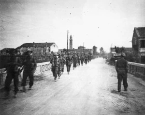 Pritchard, G E, fl 1945 : Members of 8th Platoon, B Company, 25th Battalion, marching near Massa Lombarda, Italy