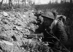 Lieutenant S W Turnbull and N F Miles of 26 New Zealand Battalion, in a slit trench during World War II, Italy