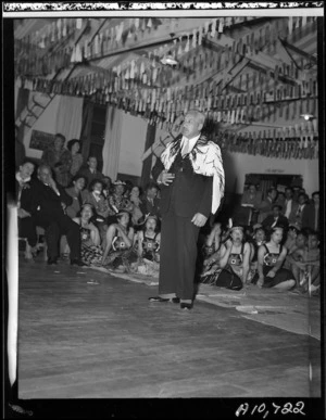 Eruera Tirikatene replying to Sir Peter Buck, during a reception given in Sir Peter's honour, Ngati Poneke Hall, Wellington - Photograph taken by W Wilson