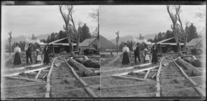 Group outside a timber mill; location unidentified