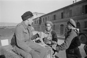 World War II soldiers of Maori Battalion, and their dog, at Forli, Italy - Photograph taken by George Frederick Kaye