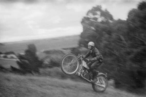 Willie O'Brien racing a motorcycle during a hill climb at Tauwhare near Hamilton