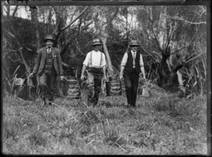 Men carrying cans labelled Hawera trout hatchery