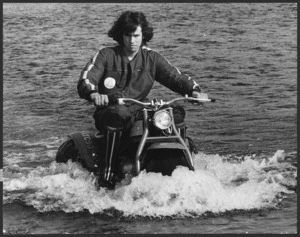 Chris Harris riding a Honda aquatic motorised trike through the Hutt River - Photograph taken by Jack Short.
