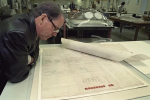 Historian Harry Evison studies a South Island sale deed - Photograph taken by Phil Reid