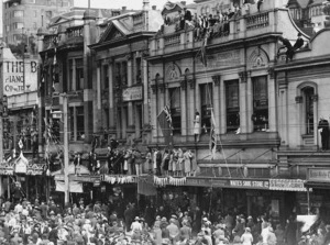 Crowd with flags and streamers on Lambton Quay, Wellington