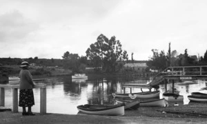 Catherine Maud Kent alongside rowboats, Lake Taupo