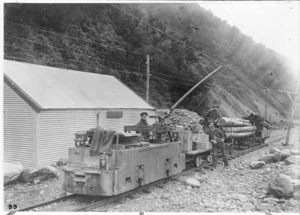 Electric locomotive, Arthurs Pass, Canterbury, on the Midland line, pulling wagons carrying explosives and timber