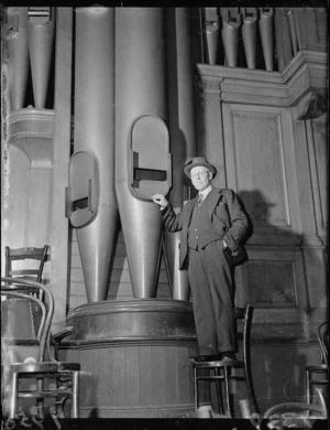 Mr H A Tustin by the Wellington Town Hall organ