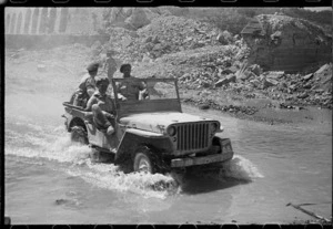 New Zealand soldiers in a jeep in Italy, crossing Pisa on the way to Florence, using the deviation by a bridge demolished by the enemy - Photograph taken by George Kaye
