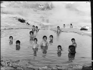 Maori children in a hot thermal pool at Whakarewarewa - Photograph taken William Henry Thomas Partington