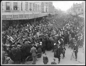 Crowd of people watching as World War I soldiers march along Colombo Street, Christchurch