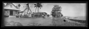 View in Samoa [probably near Apia], showing a road at the edge of a beach