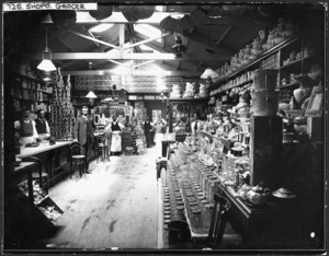 Grocery shop interior, with staff, location unidentified