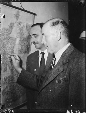 Men study a map
