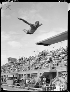 Diver Peter Healey mid-air above a diving board, 1950 British Empire Games, Auckland