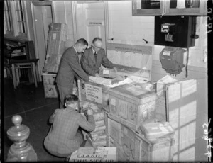 Correspondence School staff pack materials for exhibition