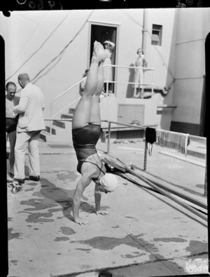 Diver doing handstand poolside, 1950 British Empire Games, Auckland
