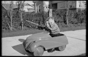 Ray sitting in a pedal car