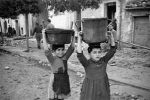 Children carrying water through the streets of Gessopalena, Italy