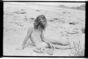 Margaret Hare sitting on a beach