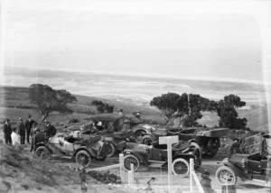 Group of men with their automatic cars on the Summit Road, Christchurch