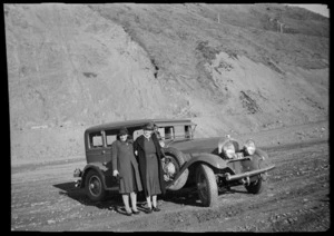 Nell and Helen Hare standing beside their Auburn car