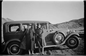 Nell and Helen Hare standing beside Auburn car