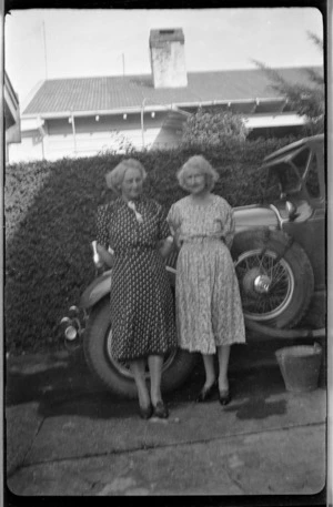Helen Hare and her sister standing beside Auburn car