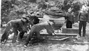 Group of men pushing a mine