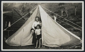 Mary Glover Bibby, her son Ron, and Eric Baker, in a tent by the Bibby family bach at Kairakau Beach, Hawke's Bay