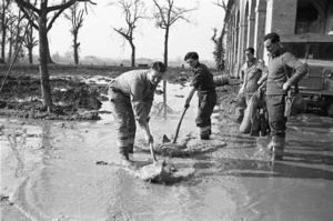George Kaye, 1914- (Photographer) : Members of an English unit clearing mud and water to allow for better drainage in the rear of 4th NZ Field Regiment positions of Faenza, Italy