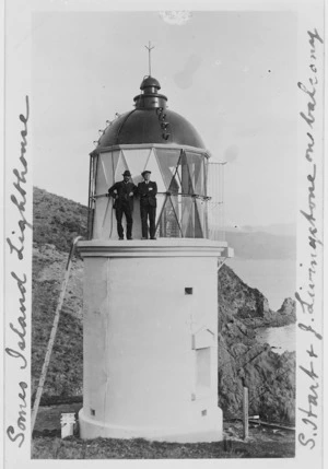 Samuel Hart and J Lewis standing on the balcony of the lighthouse on Somes Island