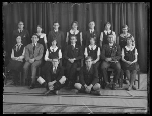 Formal group photographed on a stage