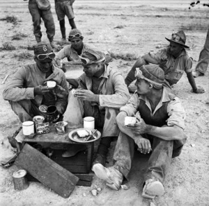 Members of the New Zealand Railway Construction Company having a snack, Western Desert