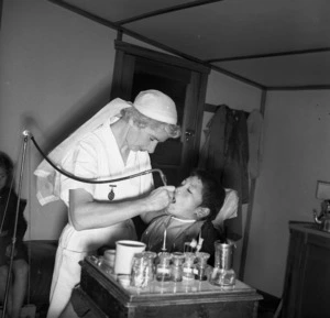 Dental nurse giving a boy treatment at the Dental Clinic