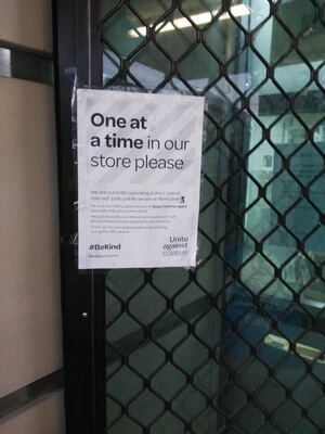 Digital photograph of COVID-19 signage at Payless Mini Mart, Newtown
